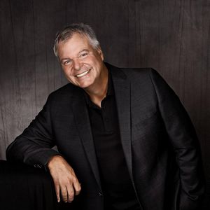 Matthias Rimmele lehnend und entspannt lächelnd